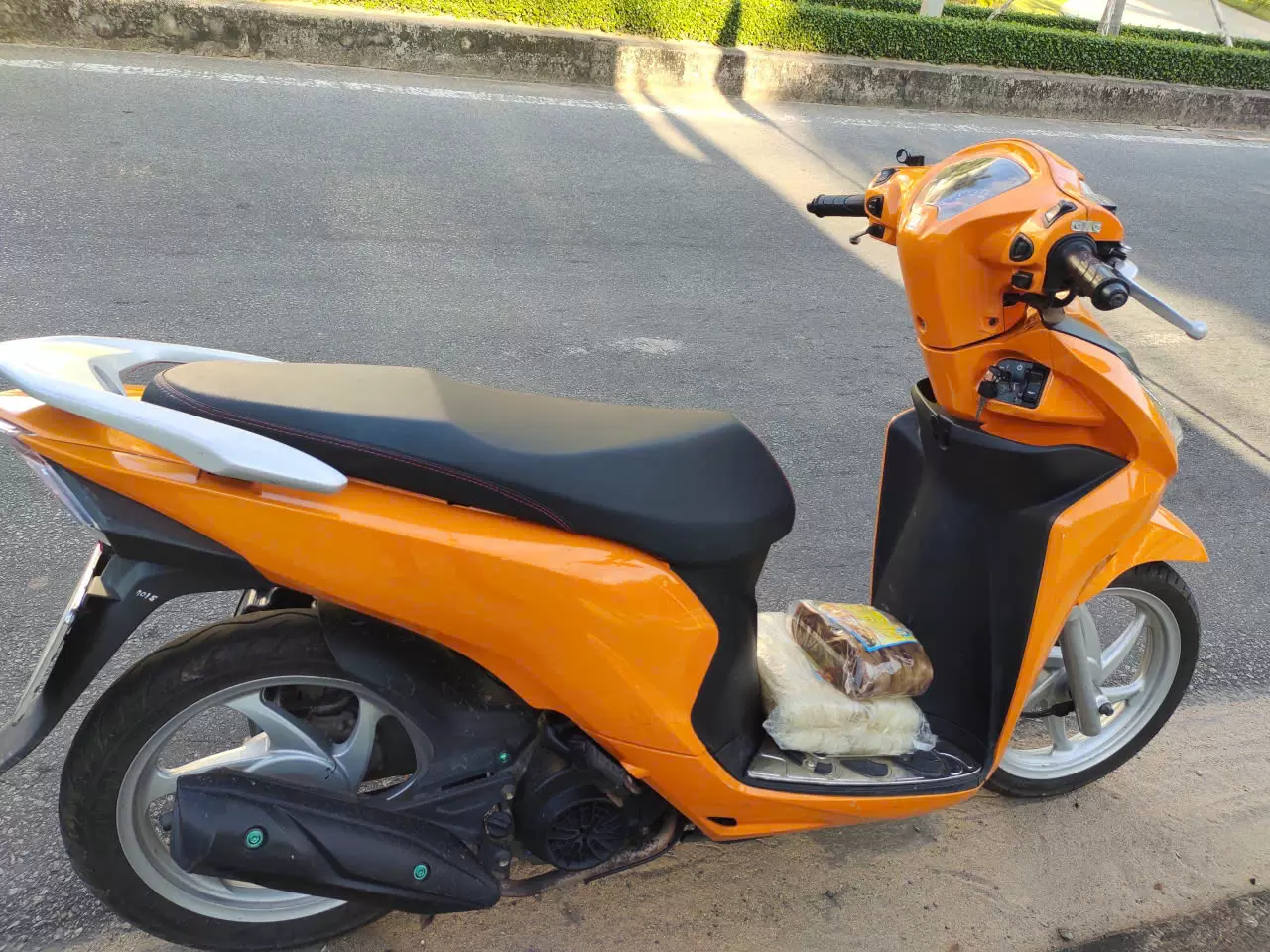 Honda Vision motorbike orange black