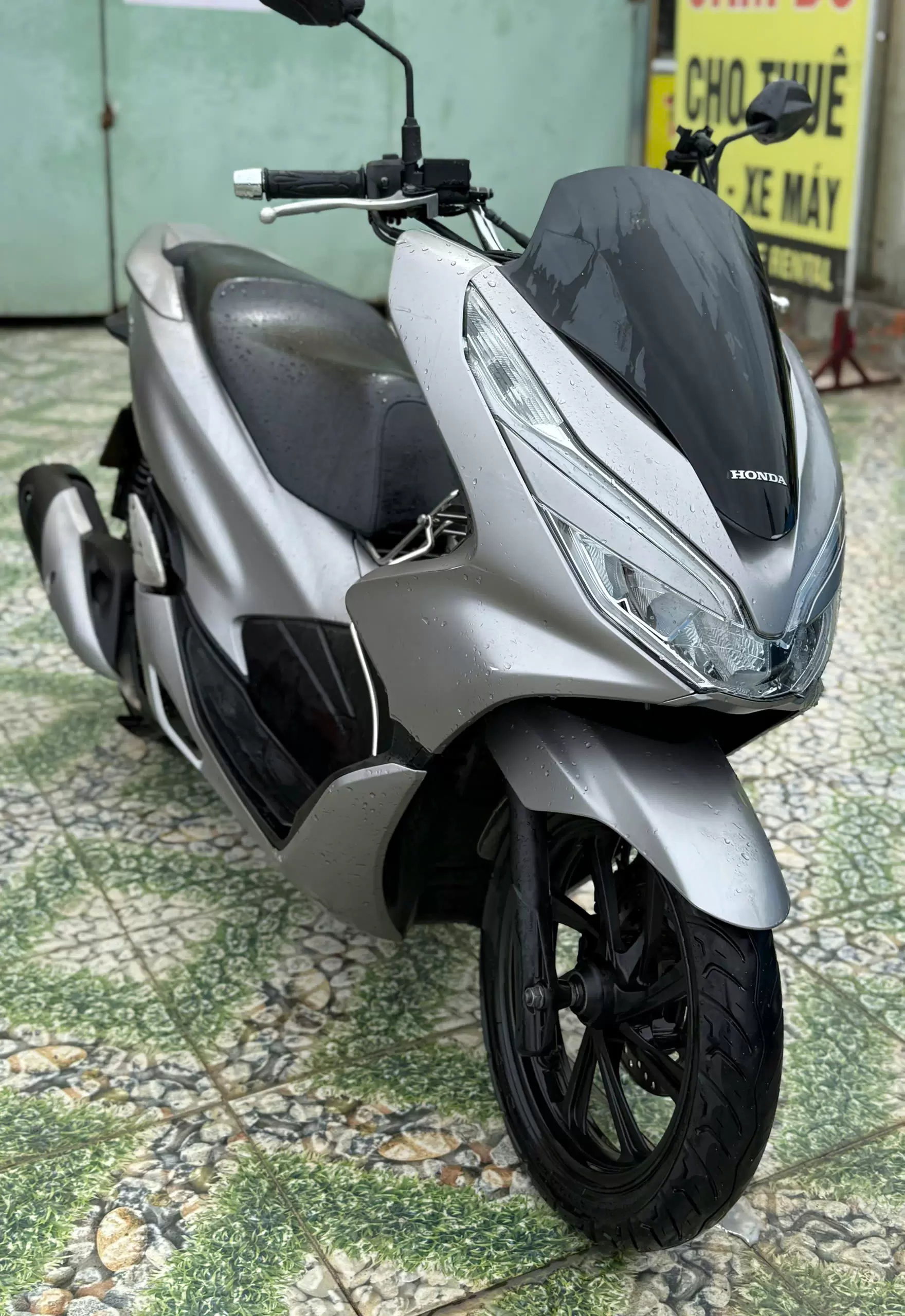 Honda PCX motorbike, silver gray, red